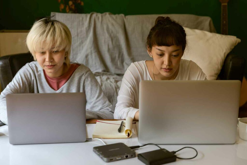 Two women working on their computers