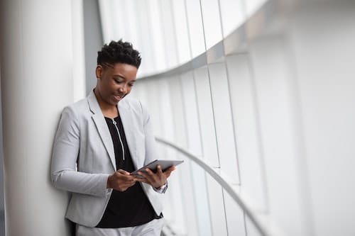 A business women looks down at her tablet