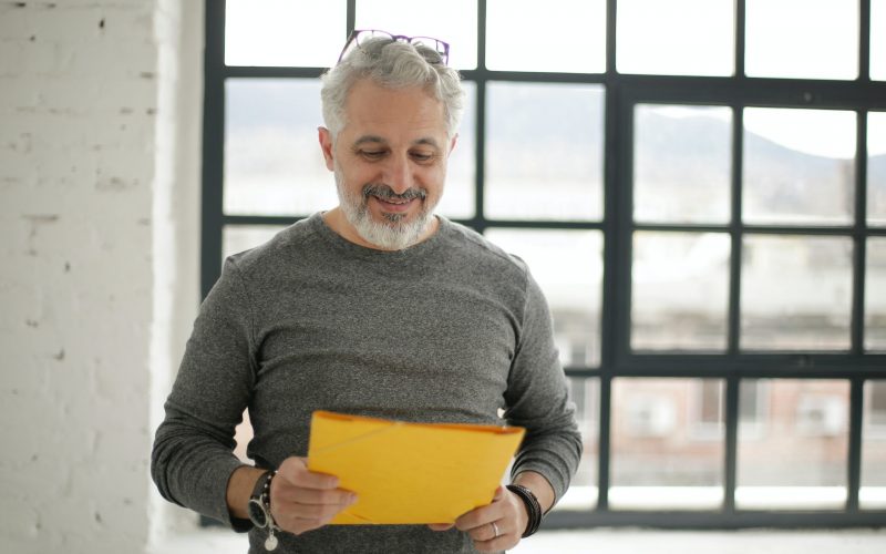 A man smiles at his perfectly kept books