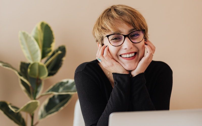 A women at a computer is happy accounting doesn't take up her time anymore